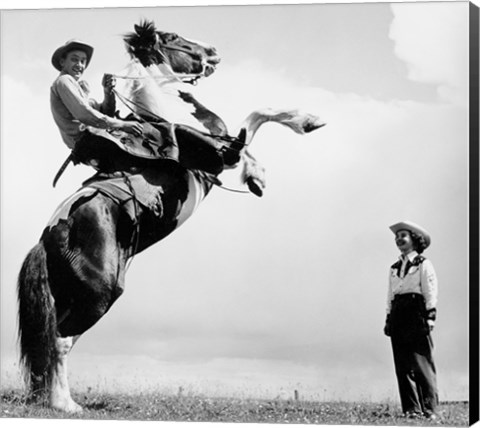 Framed Low angle view of a cowboy riding a bucking horse Print