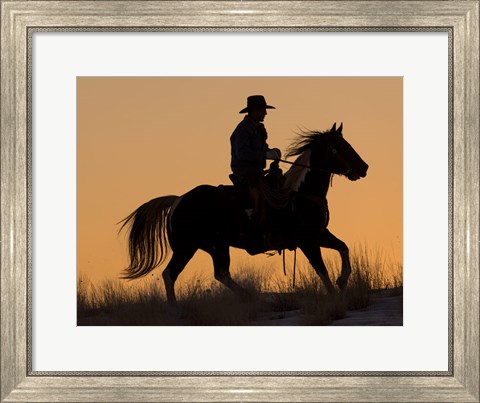 Framed Cowboy Riding His Horse Winters Snow Silhouetted At Sunset Print