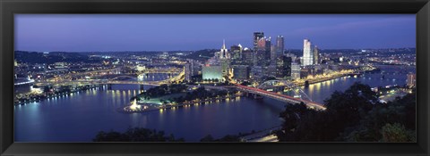 Framed Buildings along a river lit up at dusk, Monongahela River, Pittsburgh, Allegheny County, Pennsylvania, USA Print