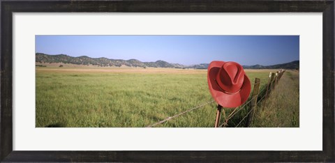 Framed USA, California, Red cowboy hat hanging on the fence Print