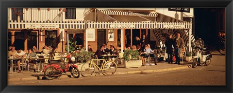 Framed Tourists sitting in a cafe, Sitges Beach, Catalonia, Spain Print