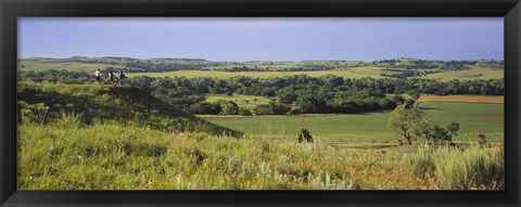 Framed Three mountain bikers on a hill, Kansas, USA Print