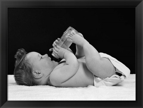 Framed 1950s Baby Lying On Back Drinking From Bottle Print
