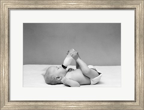 Framed 1940s Baby Prone Drinking From Milk Bottle Print