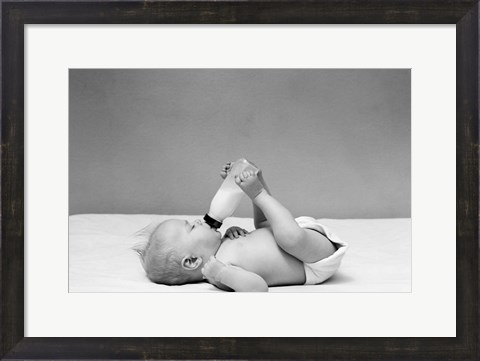 Framed 1940s Baby Prone Drinking From Milk Bottle Print