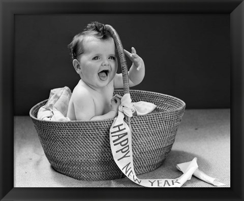 Framed 1940s Baby In Wicker Basket With Happy New Year Banner Print