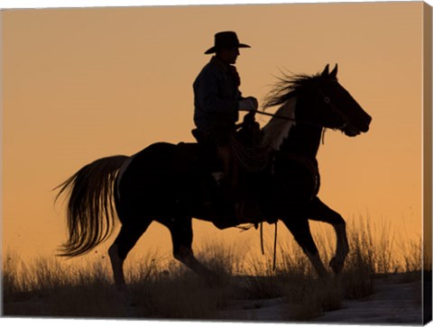 Framed Cowboy Riding His Horse Winters Snow Silhouetted At Sunset Print