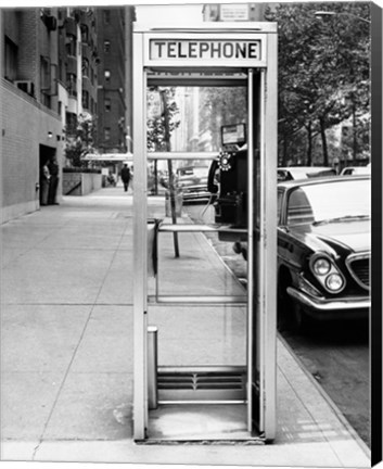 Framed Car parked at the side of a road near a telephone booth Print