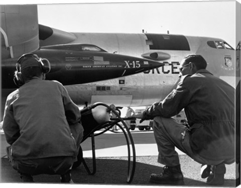 Framed Rear view of two men crouching near fighter planes, X-15 Rocket Research Airplane, B-52 Mothership Print