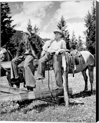 Framed Teenage cowboys sitting on rail fence Print