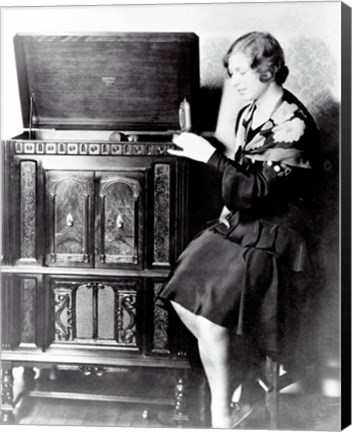 Framed Young woman sitting beside an RCA Radio-Phonograph and Home Recorder Print