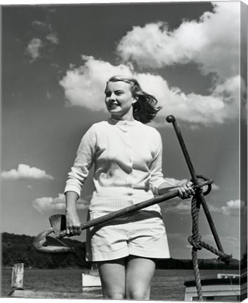 Framed Young woman standing on boat, holding anchor Print