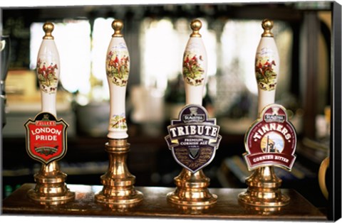 Framed Close-up of beer tap handles in a bar, London, England Print