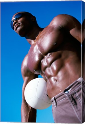 Framed Low angle view of a young man holding a volleyball Print