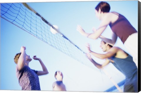 Framed Low angle view of two young couples playing beach volleyball Print