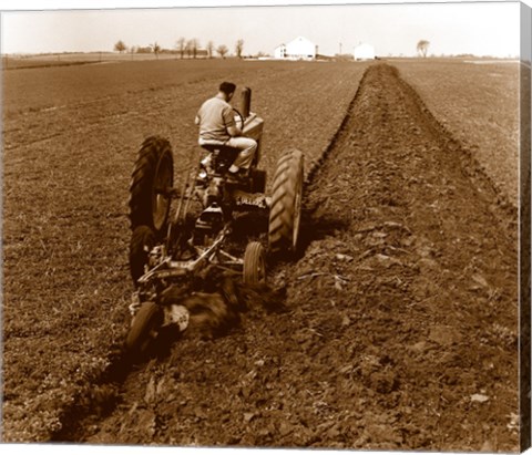 Framed USA, Pennsylvania, Farmer on Tractor Plowing Field Print