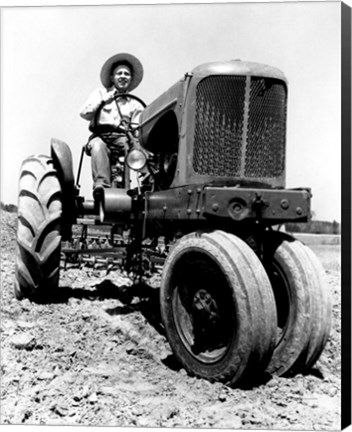 Framed Farmer Sitting on a Tractor in a Field Print