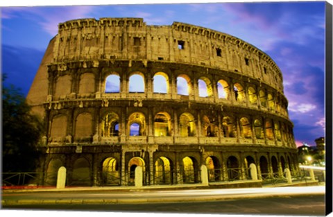 Framed Low angle view of the old ruins of an amphitheater lit up at dusk, Colosseum, Rome, Italy Print