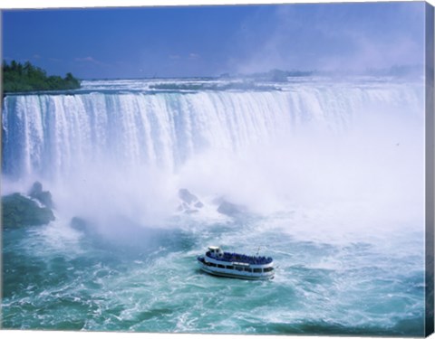 Framed High angle view of a tourboat in front of a waterfall, Niagara Falls, Ontario, Canada Print