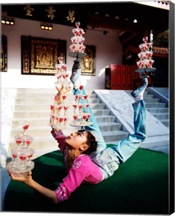 Framed Acrobat balancing glasses, Shanghai, China Print