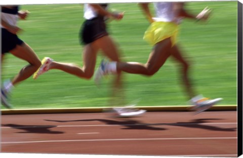 Framed Low section view of male athletes running on a running track Print