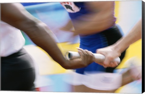 Framed Mid section view of runners exchanging baton at a relay race Print