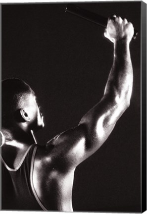 Framed Male runner holding up a relay baton Print