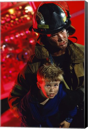 Framed Close-up of a firefighter carrying a boy Print