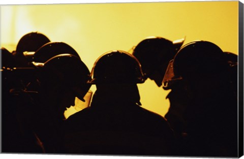 Framed Rear view of a group of firefighters looking down Print