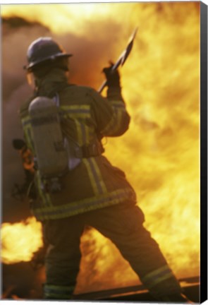 Framed Rear view of a firefighter holding an axe Print