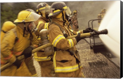 Framed Side profile of a group of firefighters holding water hoses Print