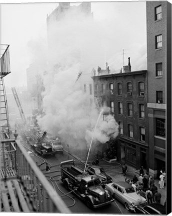 Framed New York City, Fire on East 47th Street, with fire engines shooting water on burning building Print