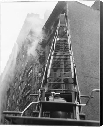 Framed Fire engine with ladder up burning building Print