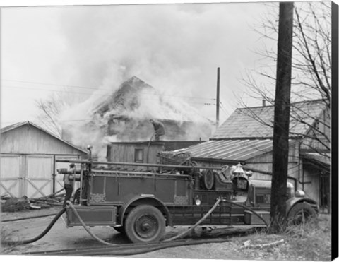 Framed Fire engine next to home in fire Print