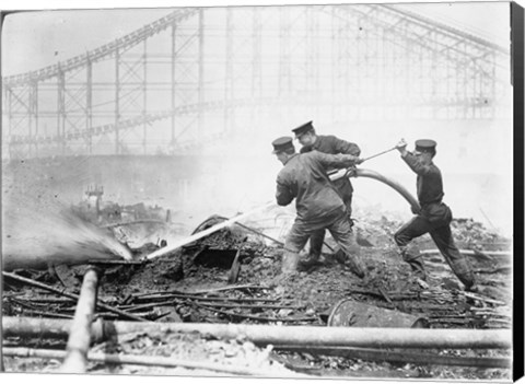 Framed Three firefighters extinguishing a fire Print