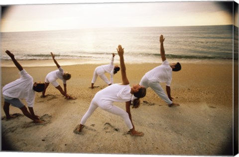 Framed Group of people performing yoga on the beach Print