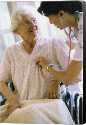 Framed Female nurse checking a female patient&#39;s heartbeat Print