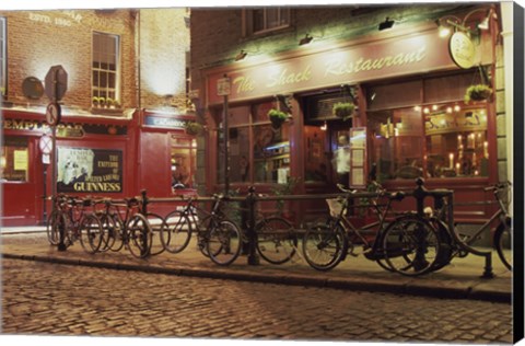 Framed Bicycles parked in front of a restaurant at night, Dublin, Ireland Print