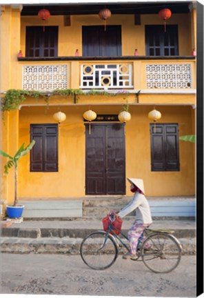 Framed Person riding a bicycle in front of a cafe, Hoi An, Vietnam Print