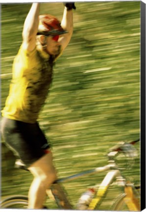 Framed Young man sitting on a bicycle with his arms raised Print