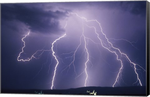 Framed Lightning bolts striking the earth Print