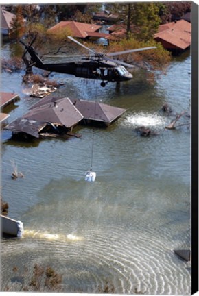 Framed Blackhawk helicopter drops sandbags into an area where the levee broke due to Hurricane Katrina Print