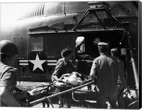 Framed Army soldiers carrying an injured person in a helicopter Print