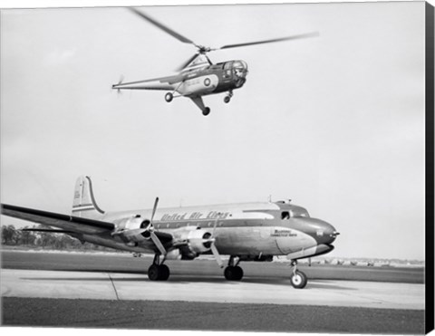 Framed Low angle view of a helicopter in flight and an airplane at an airport, Sikorsky Helicopter, Douglas DC-4 Print