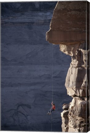 Framed Man hanging from a rope on the edge of a cliff Print