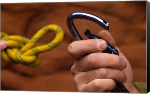 Framed Close-up of human hands holding a carabiner and rope Print