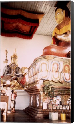 Framed Young Girl Praying in Front of a Giant Buddha Statue Print