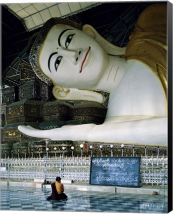 Framed Monk Sitting in Front of a Buddha Statue Print