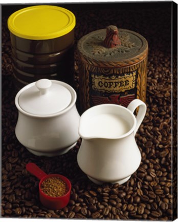 Framed Close-up of a mug of milk with a measuring spoon and jars on coffee beans Print