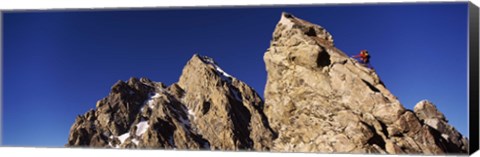 Framed Low angle view of a man climbing up a mountain, Rockchuck Peak, Grand Teton National Park, Wyoming, USA Print